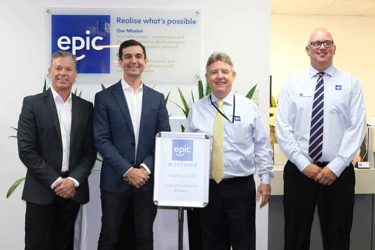 Mr Trevor Evans MP (second from left) with EPIC Assist's Nigel Hendy, Bill Gamack and Dean Graham standing in the foyer of EPICs Head Office